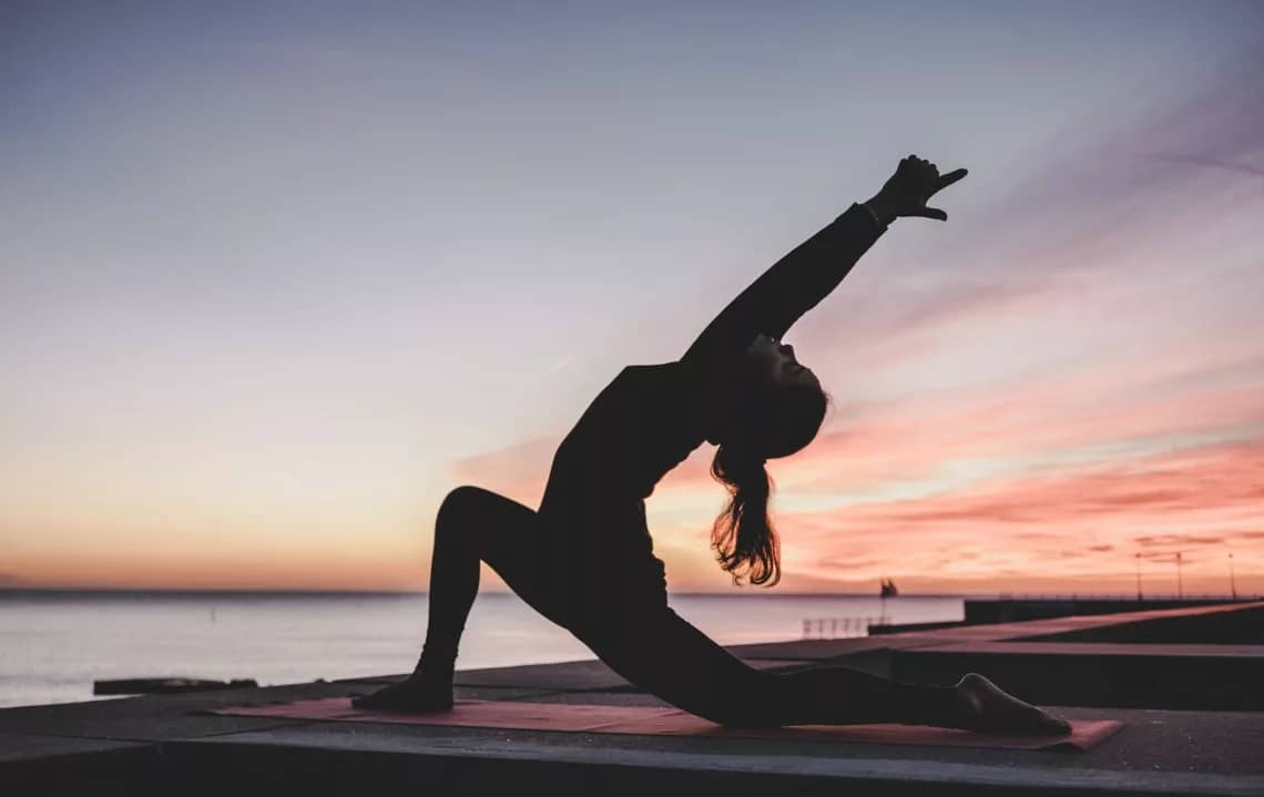 silhouette photography of woman doing yoga exercise