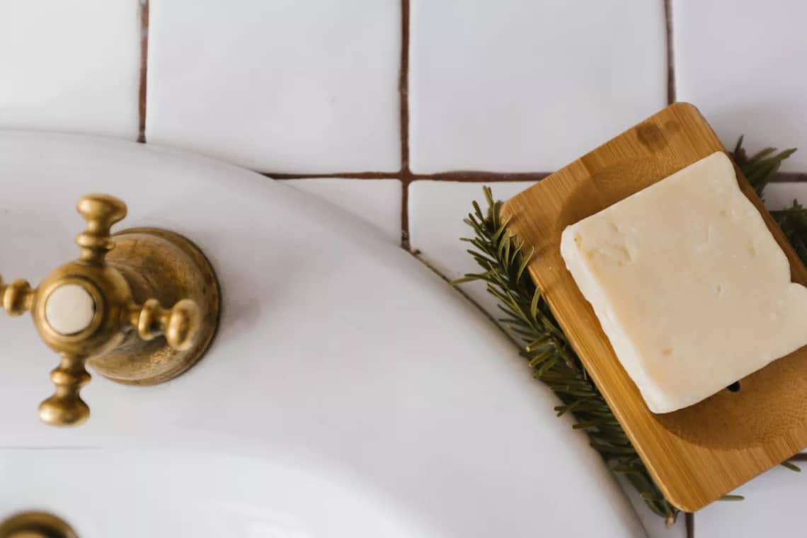 gold round ornament on white ceramic sink