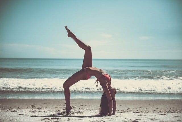 woman exercising on the beach
